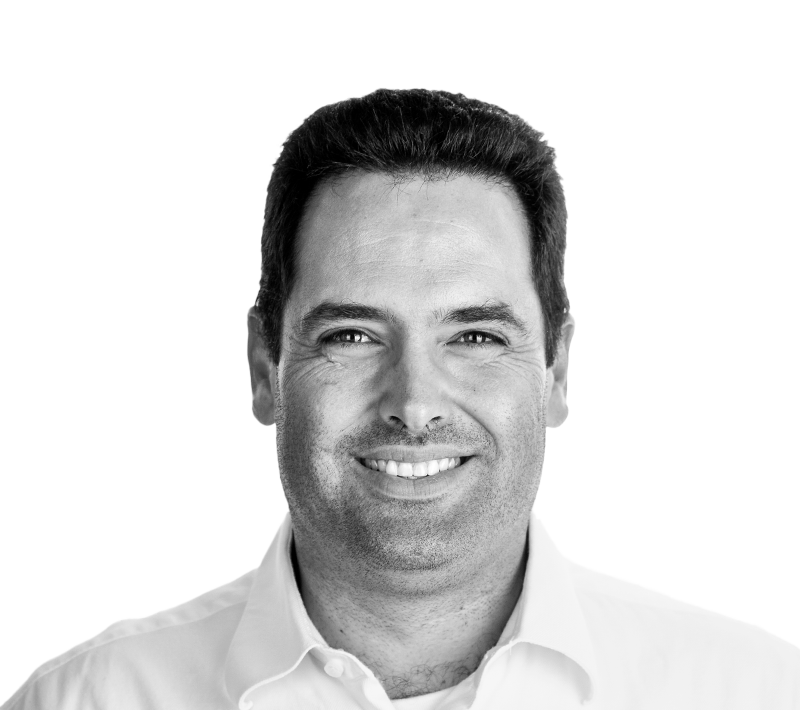 Black and white portrait of Manuel Julien, smiling and wearing a collared shirt, likely a key figure at Andea, a software provider for manufacturing execution systems (MES) and advanced planning and scheduling (APS).