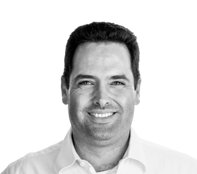 Black and white portrait of Manuel Julien, smiling and wearing a collared shirt, likely a key figure at Andea, a software provider for manufacturing execution systems (MES) and advanced planning and scheduling (APS).